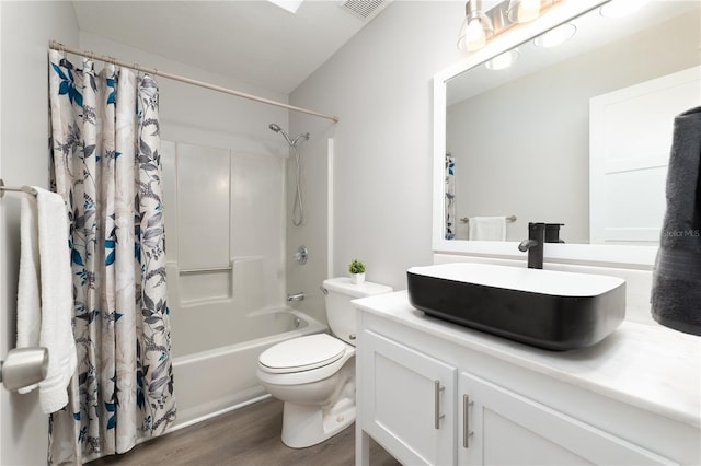 bathroom with shower / bath combination with curtain, visible vents, toilet, vanity, and wood finished floors