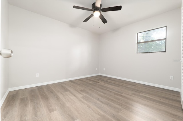 unfurnished room with ceiling fan, baseboards, and wood finished floors