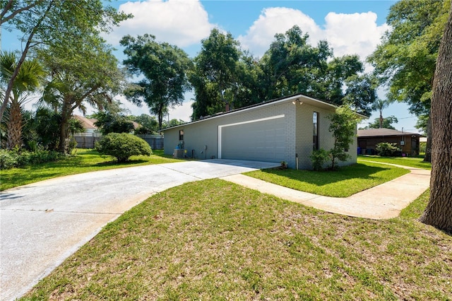 view of front facade featuring a garage, driveway, a front lawn, and brick siding