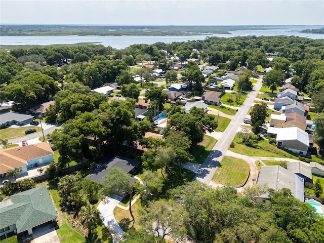 aerial view featuring a forest view, a water view, and a residential view