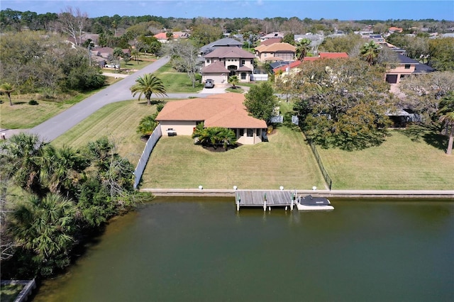 drone / aerial view with a water view and a residential view