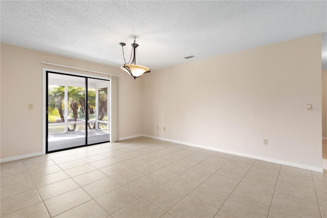 spare room featuring baseboards, a textured ceiling, and light tile patterned flooring