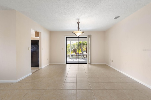 spare room featuring visible vents, baseboards, and light tile patterned floors