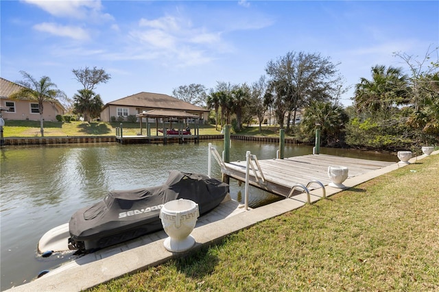 view of dock featuring a lawn and a water view