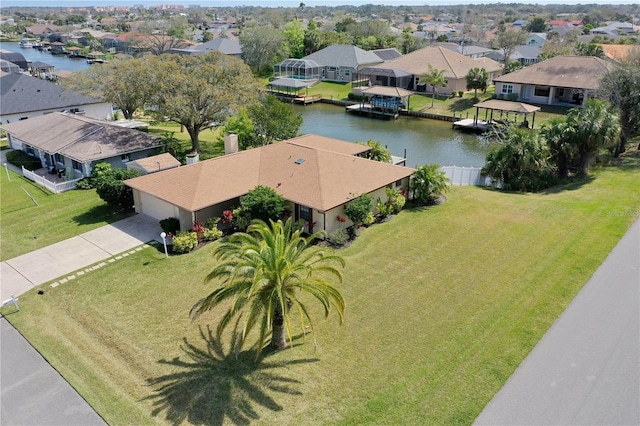 birds eye view of property featuring a water view and a residential view