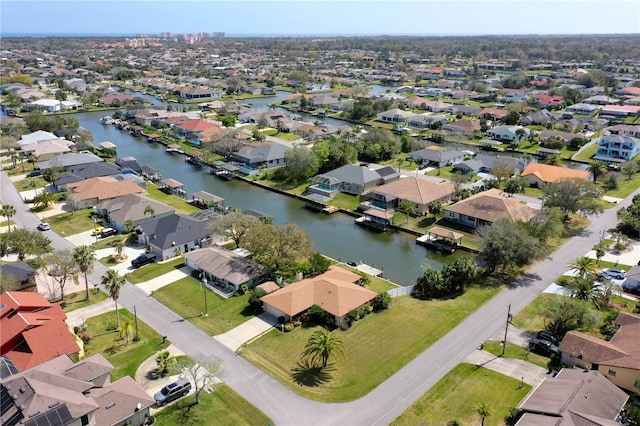 drone / aerial view with a water view and a residential view