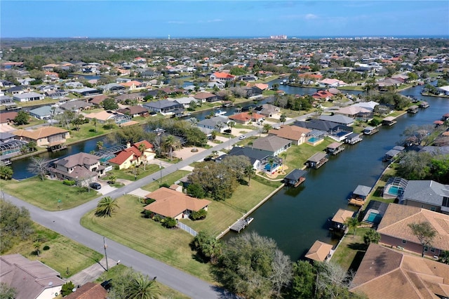 birds eye view of property with a water view and a residential view