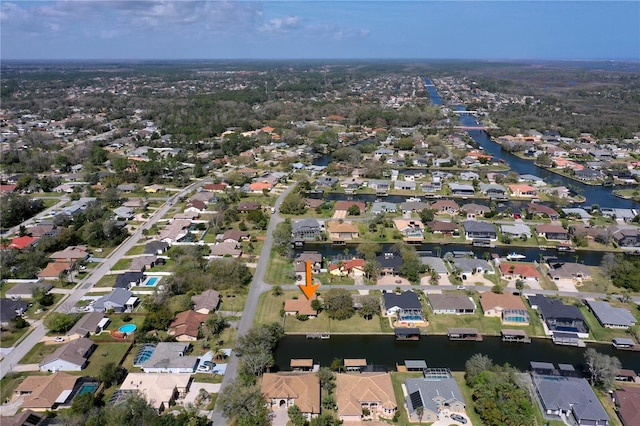 drone / aerial view with a water view and a residential view