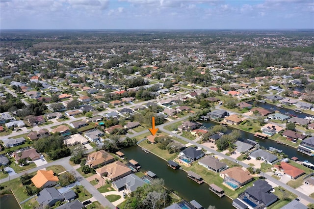 birds eye view of property with a water view and a residential view