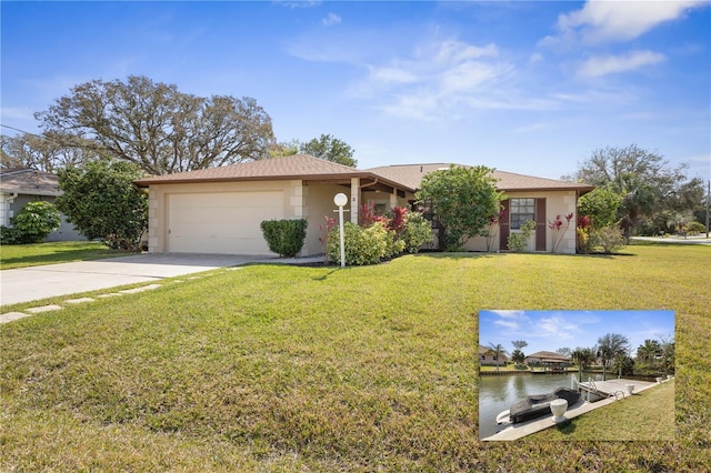 ranch-style house with an attached garage, a water view, concrete driveway, stucco siding, and a front yard