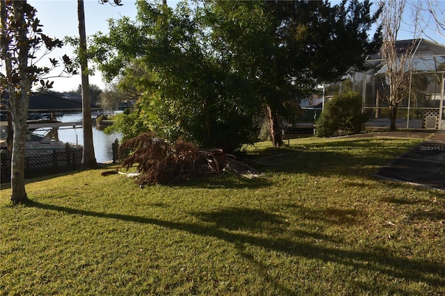 view of yard featuring a water view and a lanai