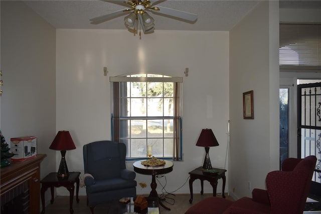 living area featuring ceiling fan