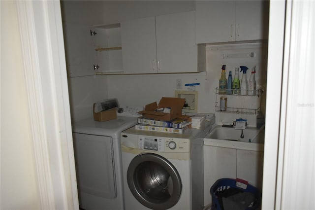 laundry area with cabinet space and separate washer and dryer