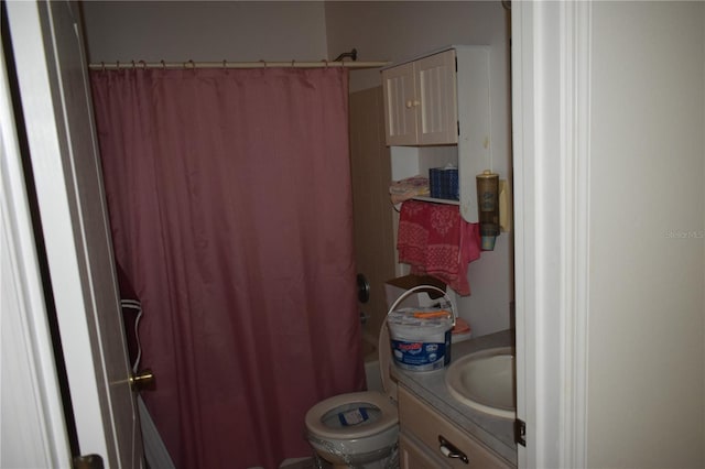 bathroom featuring toilet, vanity, and shower / tub combo with curtain