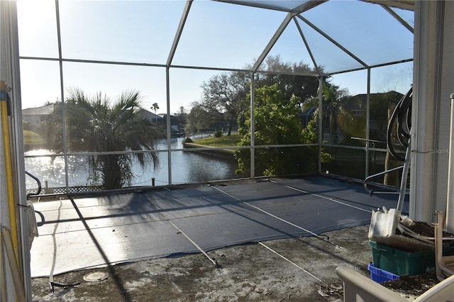 unfurnished sunroom with a water view