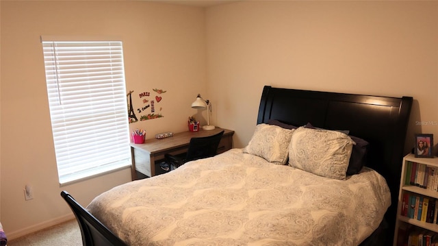 carpeted bedroom featuring baseboards