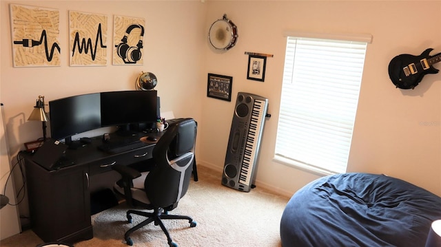 home office featuring carpet, plenty of natural light, and baseboards