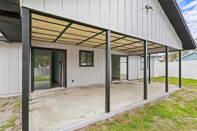 view of patio with a carport and fence