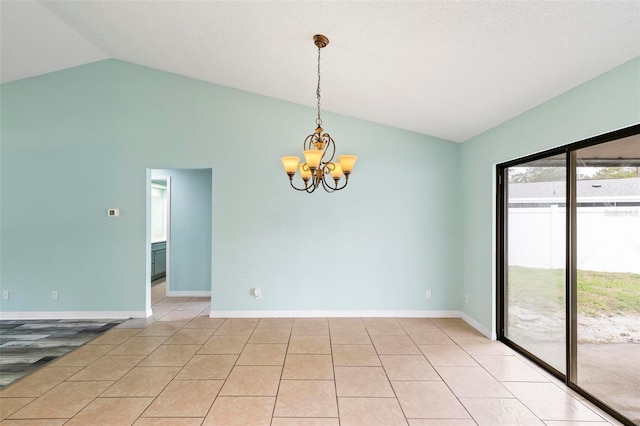 unfurnished room featuring a notable chandelier, vaulted ceiling, baseboards, and light tile patterned floors