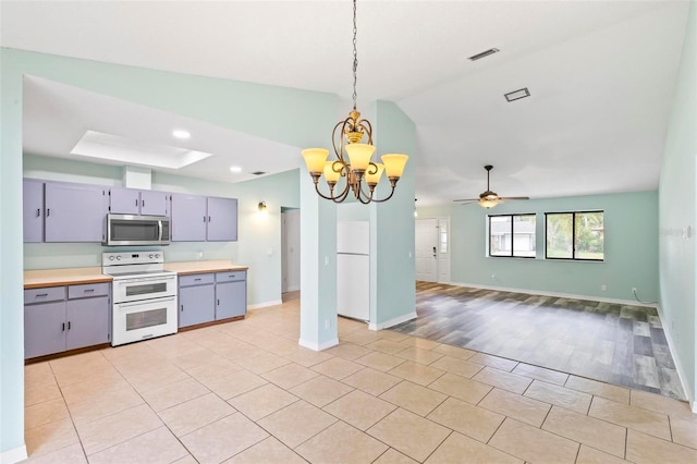 kitchen featuring range with two ovens, gray cabinetry, visible vents, light countertops, and stainless steel microwave