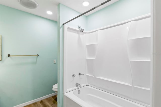 bathroom featuring recessed lighting, toilet, tub / shower combination, wood finished floors, and baseboards