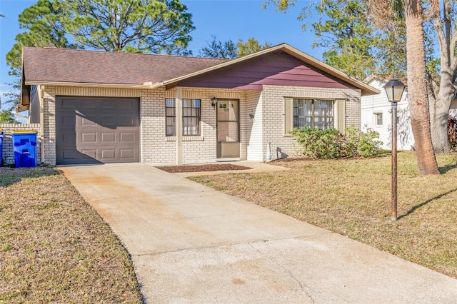 single story home with a garage, driveway, a shingled roof, a front lawn, and brick siding