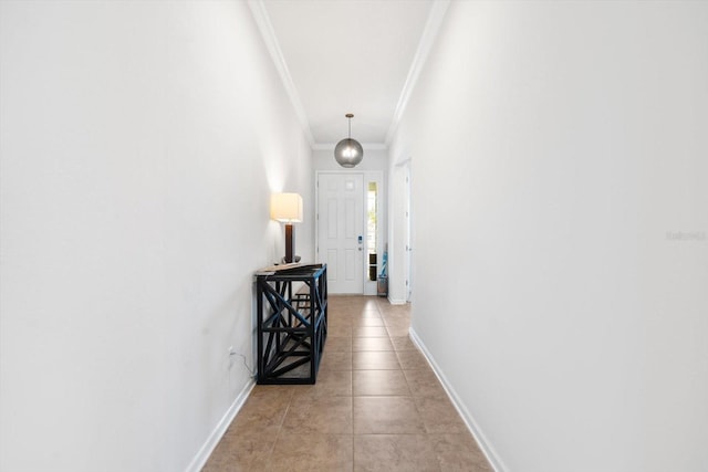 hallway featuring light tile patterned floors, baseboards, and ornamental molding