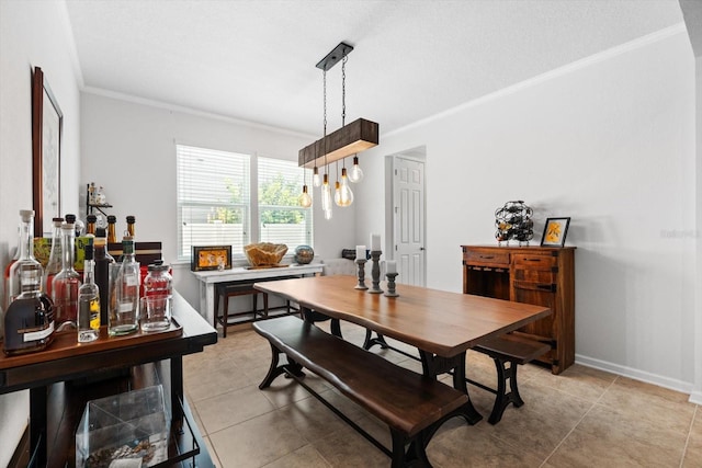 dining room with light tile patterned floors, ornamental molding, and baseboards