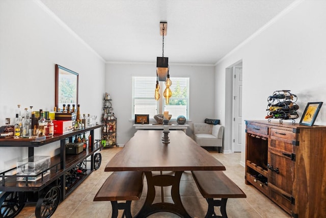 dining room with crown molding and light tile patterned flooring