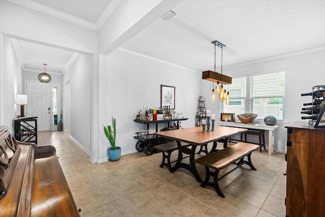 dining room with light tile patterned floors, baseboards, visible vents, and ornamental molding