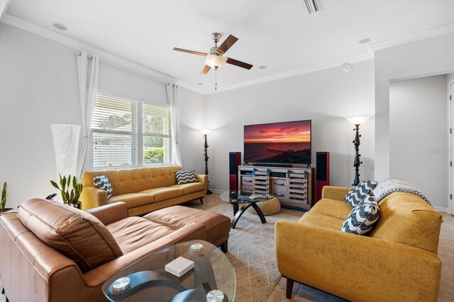 living area with baseboards, a ceiling fan, visible vents, and crown molding