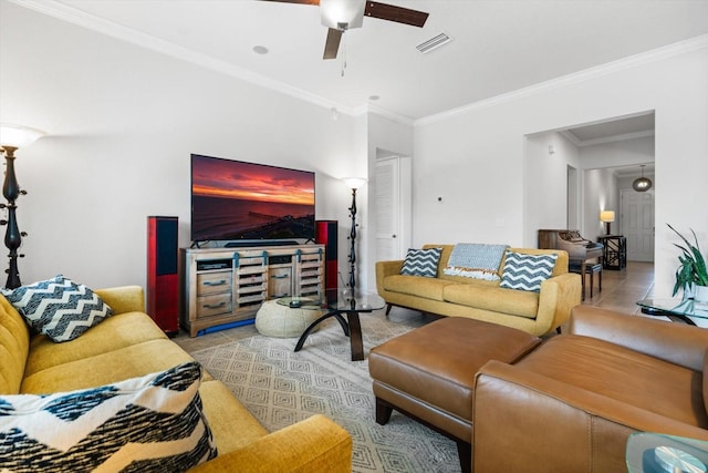 living room featuring light tile patterned floors, ceiling fan, ornamental molding, and visible vents