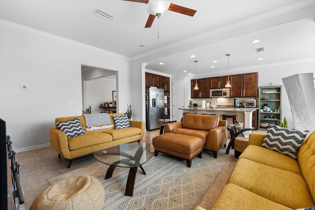 living room featuring light tile patterned flooring, recessed lighting, visible vents, baseboards, and ornamental molding