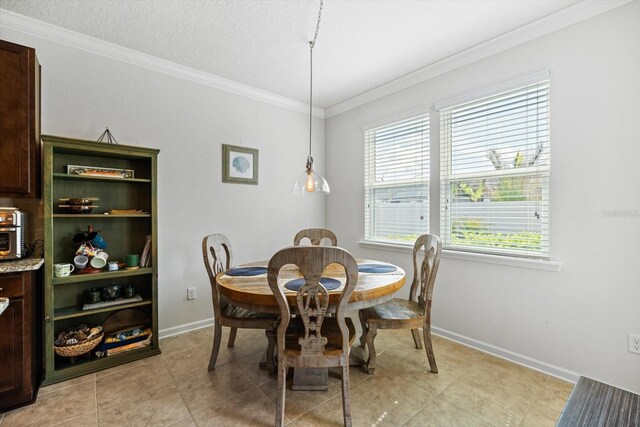 dining area with crown molding, a textured ceiling, baseboards, and light tile patterned floors