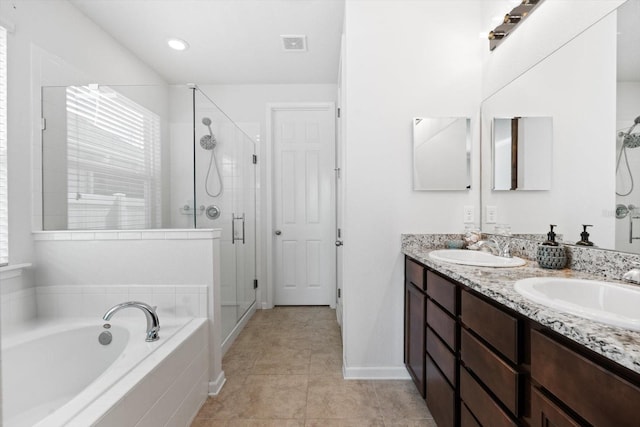 bathroom featuring a garden tub, a shower stall, visible vents, and a sink