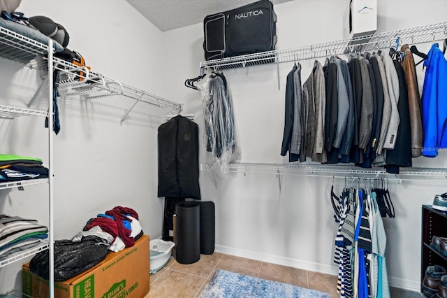 spacious closet featuring tile patterned flooring