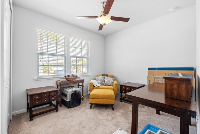 sitting room with carpet floors, baseboards, and a ceiling fan