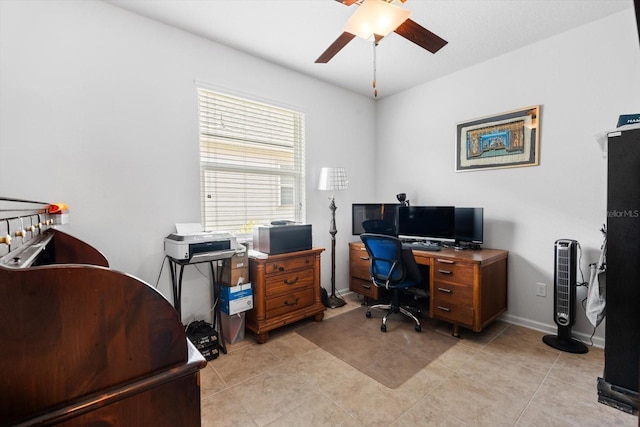 home office with ceiling fan, baseboards, and light tile patterned floors