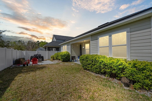 exterior space featuring a yard, a patio area, and fence