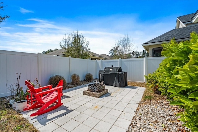 view of patio / terrace with a fenced backyard and a fire pit