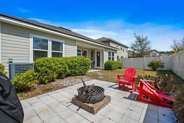 view of patio / terrace with a fenced backyard and a fire pit