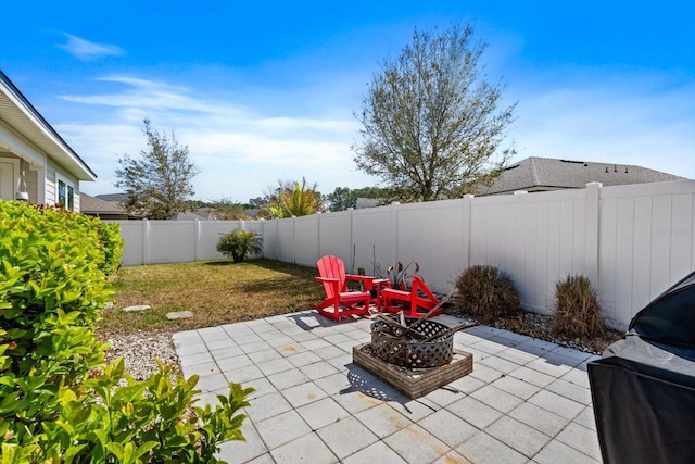 view of patio / terrace with an outdoor fire pit, a fenced backyard, and a grill