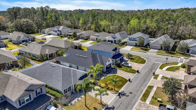 birds eye view of property featuring a residential view and a view of trees