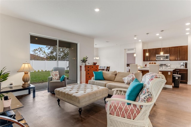 living room featuring light wood-style flooring and recessed lighting