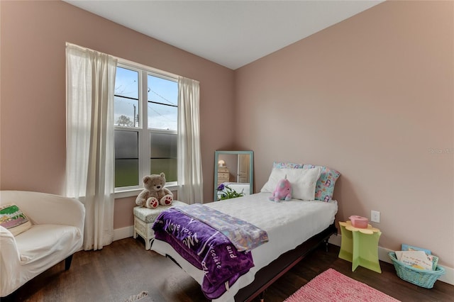 bedroom with wood finished floors and baseboards