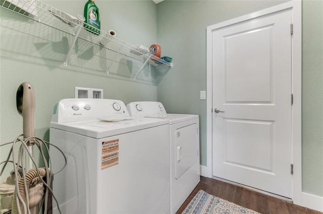 laundry area featuring laundry area, separate washer and dryer, and dark wood finished floors