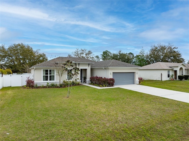 view of front of house featuring stucco siding, concrete driveway, a front yard, fence, and a garage