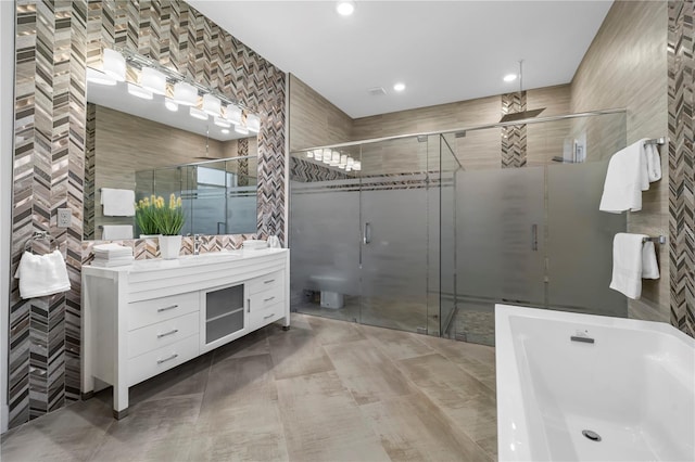 full bathroom with a freestanding bath, a stall shower, and tile walls