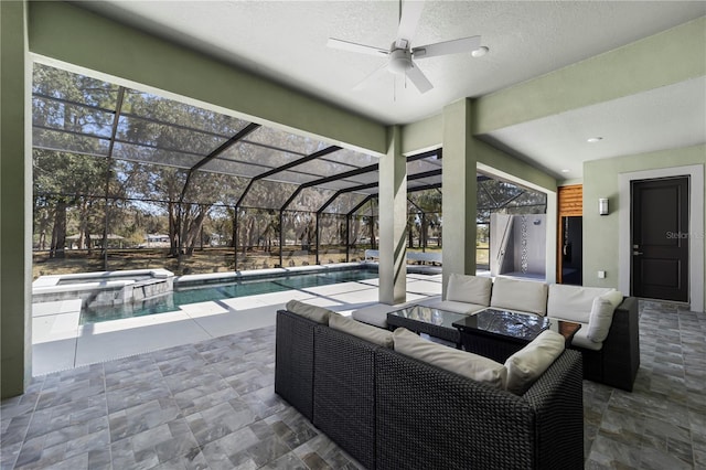 view of patio with glass enclosure, a pool with connected hot tub, an outdoor living space, and a ceiling fan