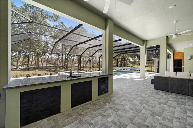 view of patio featuring glass enclosure, ceiling fan, an outdoor pool, and an outdoor living space